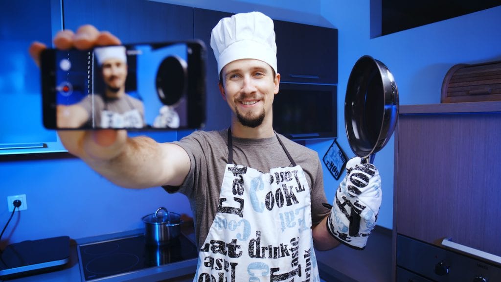 Cooking influencer shooting a video with smartphone
