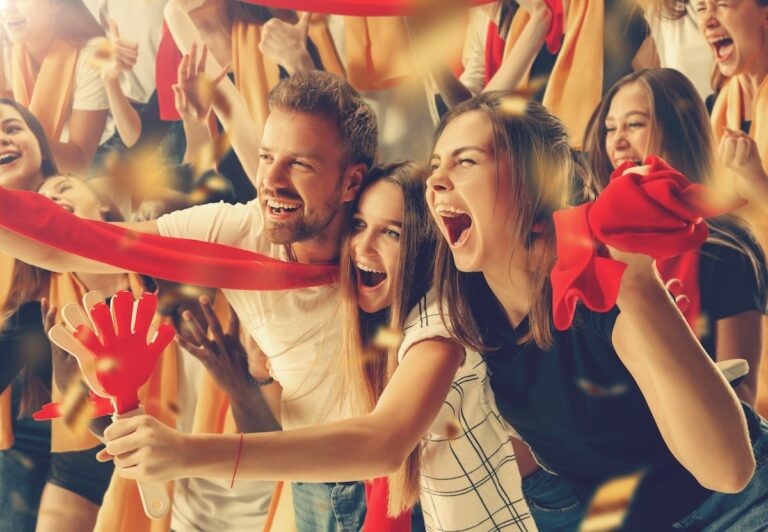 Eine Gruppe glücklicher Fans bejubelt den Sieg ihrer Mannschaft.